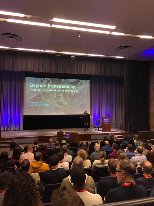 Elizabeth presents "Beyond Transparency: Next-gen communication strategies" session at the Agile Cambridge, before an audience in a large auditorium.