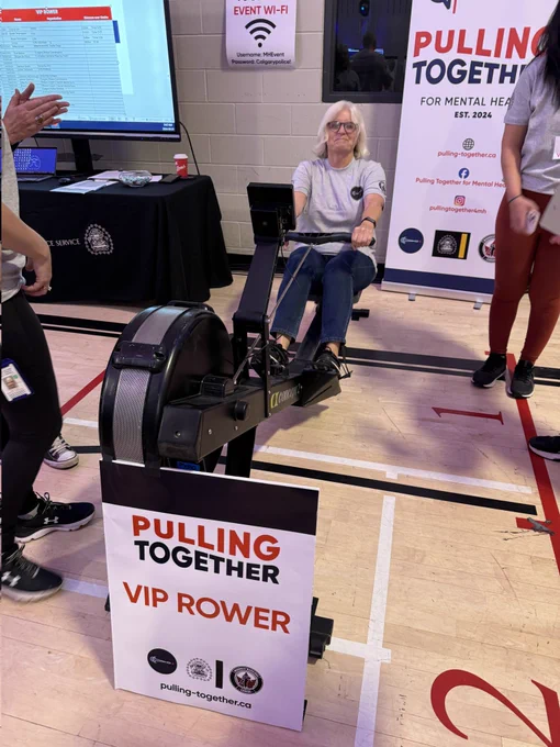Commissioner Mallon on a rows on a rowing machine at the Pulling Together event. 