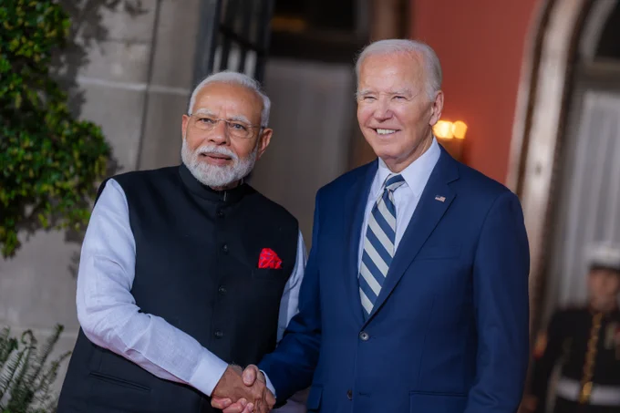 President Biden greets Prime Minister Modi of India.