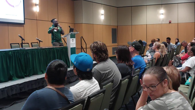 A Wayne State admissions adviser talking to a large group of people on Wayne State Campus