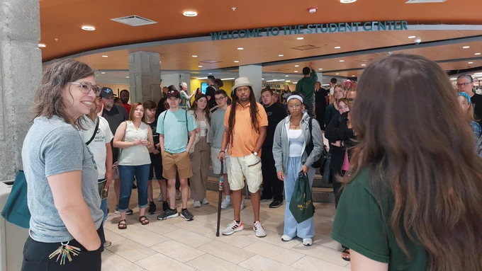 A group of people take a tour on Wayne State's campus