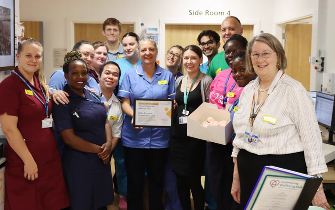 Members of the OPAU ward team holding a Tissue Donation Alliance award, presented by Alison Ryan