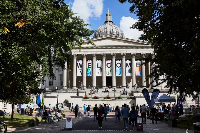 A landscape photo of UCL's Main Quad taken by James Tye.

The Portico has a banner in between it's central pillars reading 'WELCOME', and there are students and other members of our community walking around.