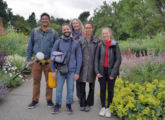Witness Trees project researchers, Sate Ahmad, Christos Chondrogiansis, Jennifer McElwain, Tina Monterio and Morgane Weissenburger, in the National Botanic Garden. They are standing on a path, surrounded by pretty flowers.