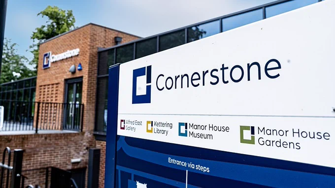 Image of Cornerstone sign with new builidng behind