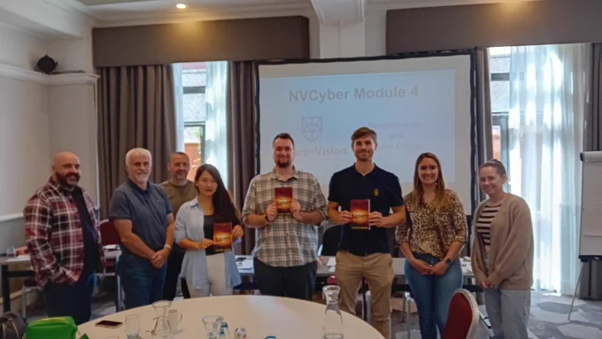 Callum, with everyone else in the training, holding up his book.