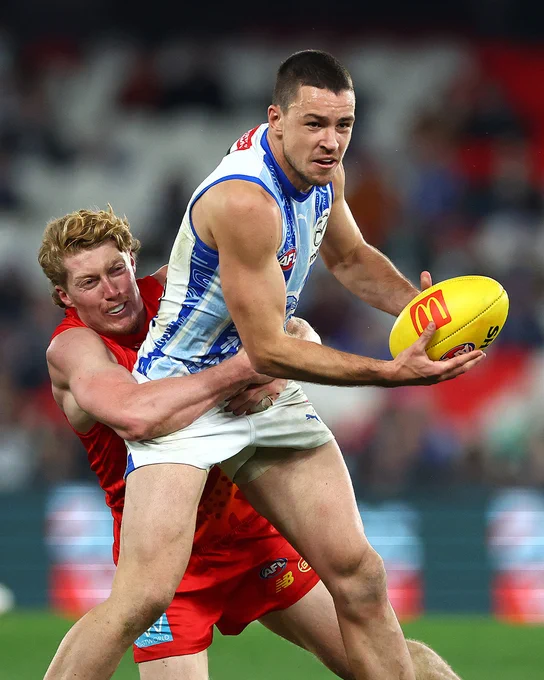 Luke Davies-Uniacke shrugs a tackle from Gold Coast's Matt Rowell in Round 21.
