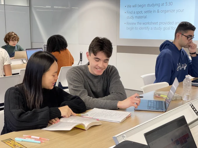 Two students studying together in Sidney Smith Commons