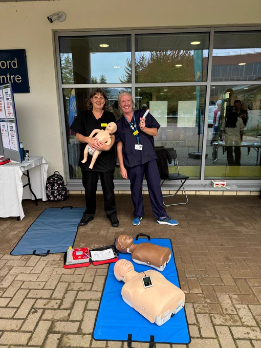Two members of RUH staff hold a CPR dummy and epi-pen
