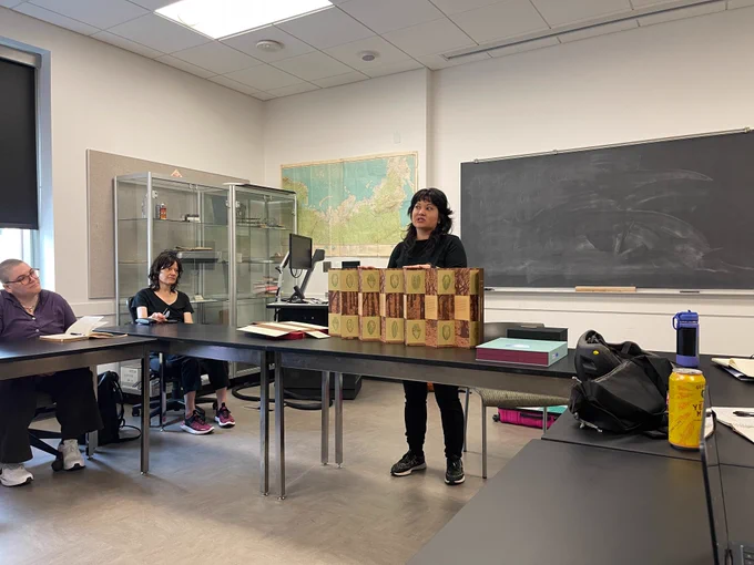 Keri stands behind a first example of a movable book with four sides