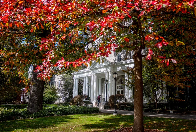 Parrish Hall surrounded by trees with red leaves.