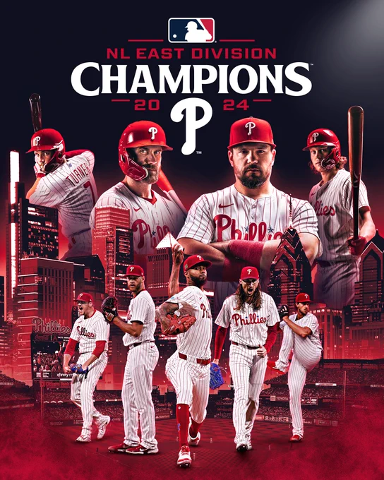 Graphic for the Phillies winning the National League East in 2024. The cutouts of players from left to right are as follows. Top row: Trea Turner, Bryce Harper, Kyle Schwarber, and Alec Bohm. Bottom row: Jeff Hoffman, Zack Wheeler, Cristopher Sánchez, Matt Strahm, and Aaron Nola. All players are wearing the red pinstripes uniforms. The skyline of Philadelphia is in the background beyond Citizens Bank Park. The NL East Champions logo is in the middle of the graphic near the top.