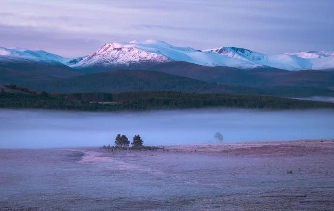 Scottish Highlands, Mountains covered in snow and in the foreground misty landscape