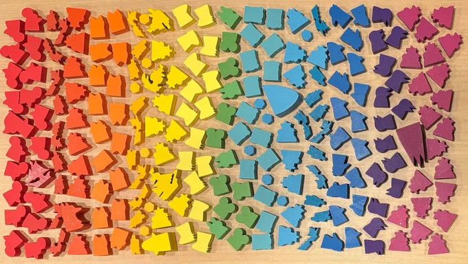 A rainbow of meeples from Leder Games' games