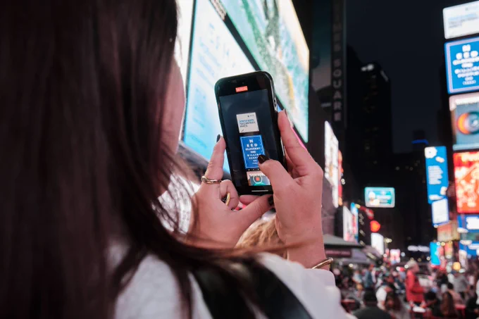 Photos of Unlock The Everyday activation in Times Square NY,, Monday 23 September. The photos capture viewers watching the campaign projections on Times Square Billboards.