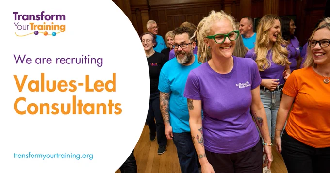 The image is a recruitment ad for "Transform Your Training," inviting applications for "Values-Led Consultants."

On the left side, the text reads:

"We are recruiting Values-Led Consultants" with "Values-Led Consultants" in bold orange text.
The "Transform Your Training" logo is at the top left, featuring purple and orange text with a multicolored line and dots underneath.
The website "transformyourtraining.org" is listed at the bottom in light blue text.
On the right side, a group of smiling people is shown walking together in a relaxed indoor setting, dressed in colorful branded t-shirts. One woman with blonde hair and green glasses, wearing a purple shirt, is at the forefront. Other participants, both men and women, are visible behind her, also smiling and engaged. The image conveys a sense of collaboration and positive energy.