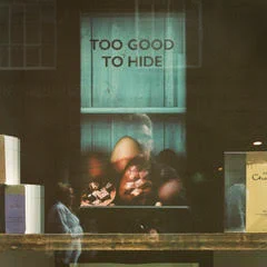colour photo of shop window with easter egg display and faint reflection of photographer