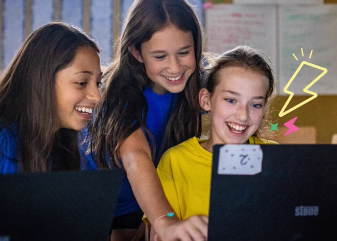 Three young creators looking at a laptop with illustrated lightening bolts and stars overlayed. 