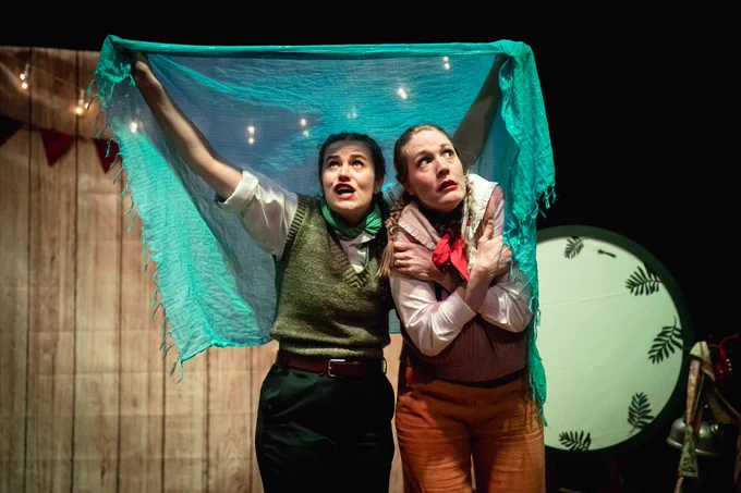 Image from 'Clomping About' of the two caravan dwellers played by actors Evie Hargreaves and Julia Frost. The set contained a campfire inspired by the ones in Sam Thompson's collections. Reproduced courtesy of Goofus Theatre & With Passion & Purpose, 2024.