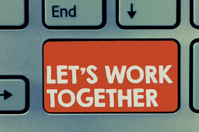 Image of a keyboard and one of the keys reads - Let's Work Together.
