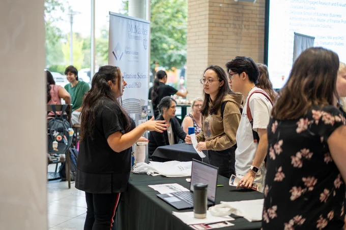 Students and reps interacting at the fair