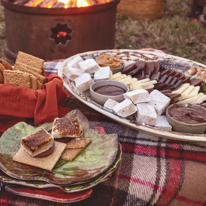 Second: A s’mores station arranged on a tray with varieties of chocolate, homemade Butter Rum Marshmallows, and graham crackers. 


