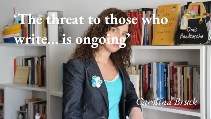 The writer Carolina Bruck stands in front of bookshelves, with a quote from her podcast interview: 'The threat to those who write… is ongoing'