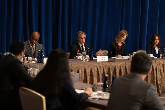 Secretary Blinken sits at a conference table speaking into a microphone in New York on September 25, 2024. (State Department/Chuck Kennedy)