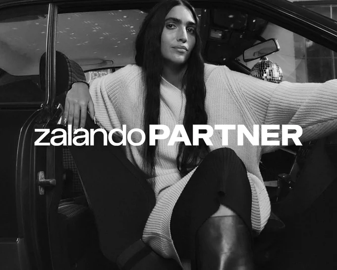 zalando Partner, a black and white photo of a woman sitting in a car with her legs out of the car. 