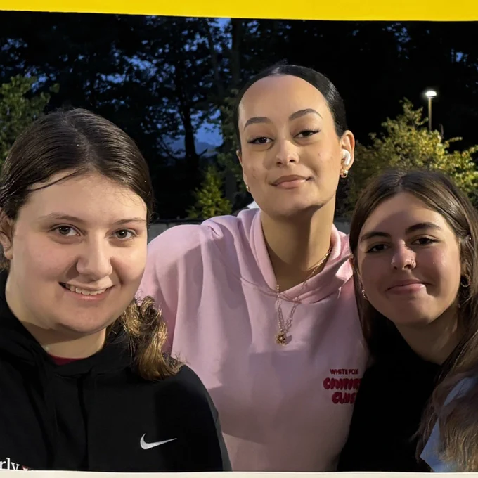 Three students posing and smiling