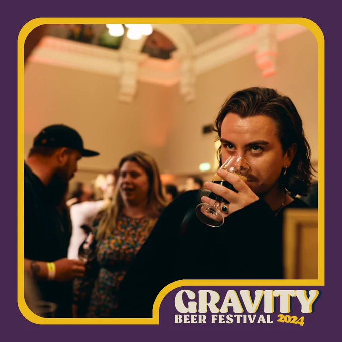 photo of a man drinking a dark looking beer at Gravity beer Festival