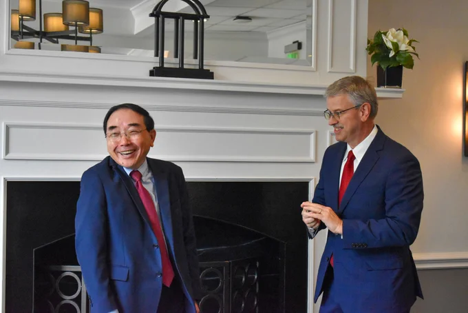 Dr. Jack Hu, UGA Provost (left) smiles while Dr. David Pittman (right) presents him with an ERDC coin.