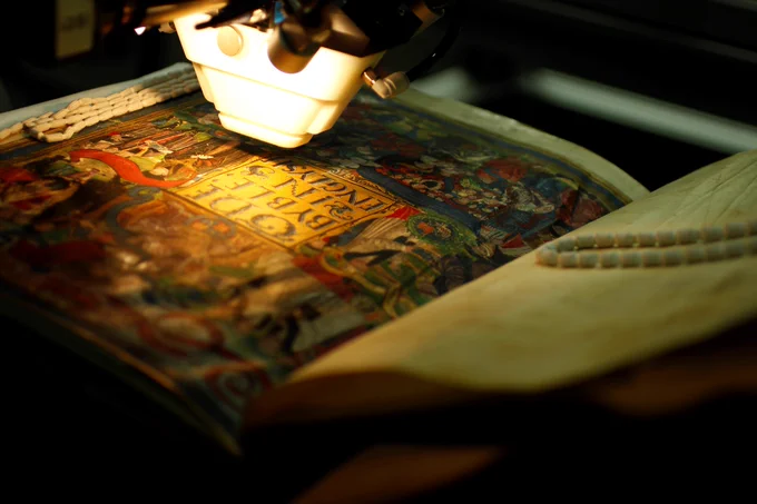 Examining a manuscript at Cambridge University Library's Cultural Heritage Imaging Laboratory.