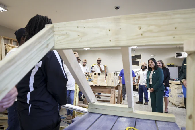 Acting Secretary Julie Su tours a carpentry workshop and chats with Job Corps students.