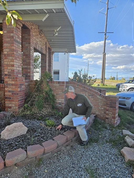 Colorado State Forest Service forester assesses a home for defensible space. 