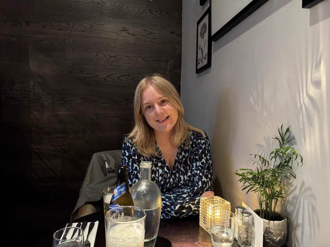 Photo shows a blonde woman in a restaurant 