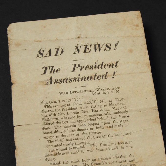 Newspaper clip that displays the words “SAD NEWS! / The President Assassinated!” along with a written text column on the subject. 