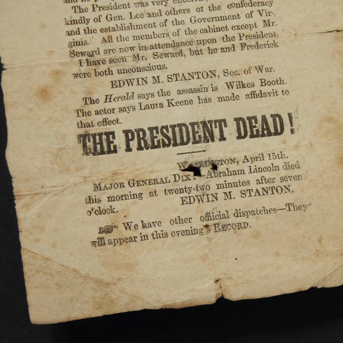 Newspaper clip that displays the words “The President Dead!” along with a written text column on the subject. 