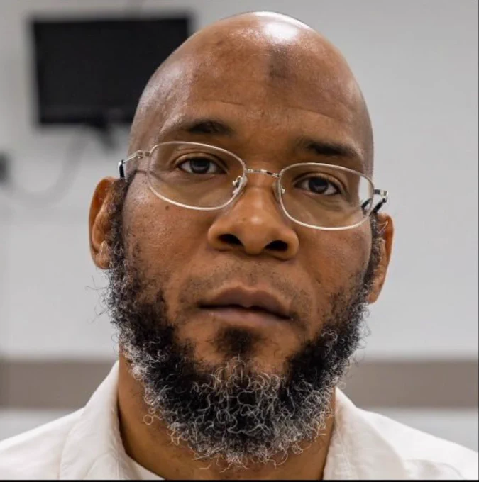 Close up photo of Marcellus Williams. He is wearing glasses and has a serious expression.