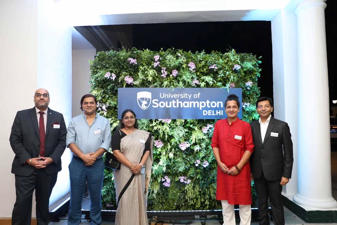 Five people standing in front of a 'University of Southampton Delhi' sign with a green floral backdrop. From left to right: Amarjit Singh, Kunal Bose, Veenu Jain, Jagmohan Bangani, and Yeshwanth Raj Parasmal.