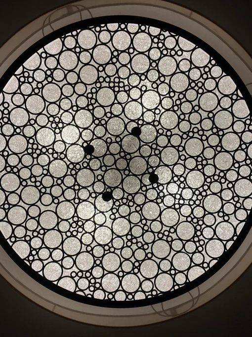 A light fixture with circles that look like a spray of bubbles