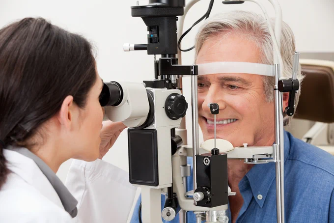 An image of a gentleman having a eye test at an opticians.