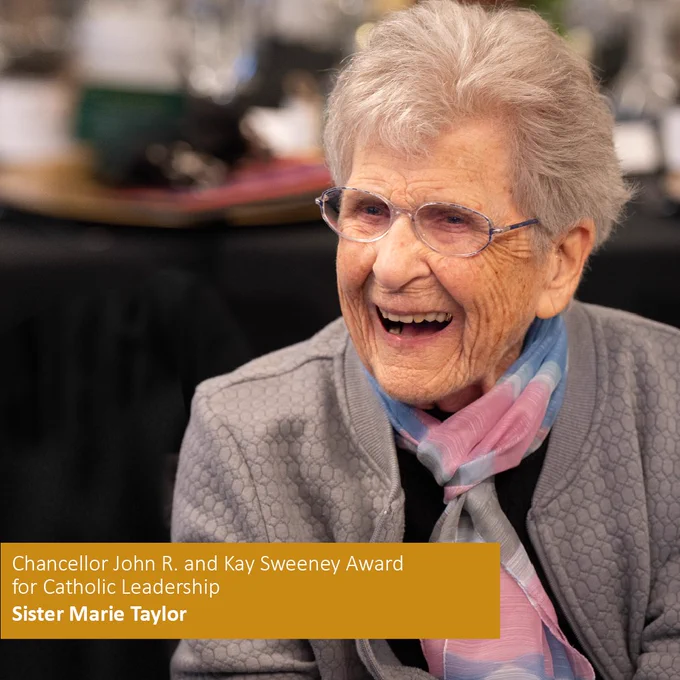 Sister Marie Taylor with gray hair, glasses, and a joyful expression at an event to receive the Chancellor John R. and Kay Sweeney Award for Catholic Leadership, named Sister Marie Taylor.