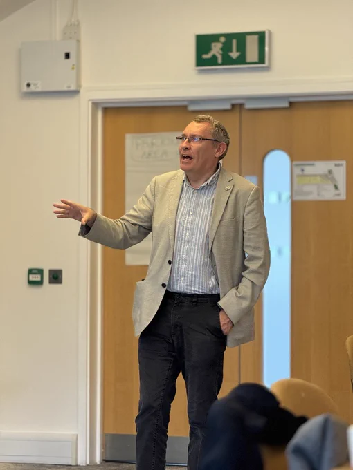 Tim Foxon at the EDRC Whole Centre Meeting, speaking in front of an audience.