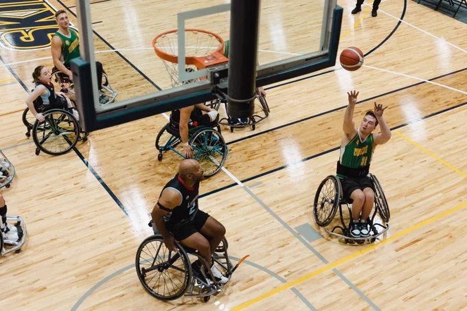 Wheelchair basketball player shooting a basketball at the SC4 Fieldhouse gym