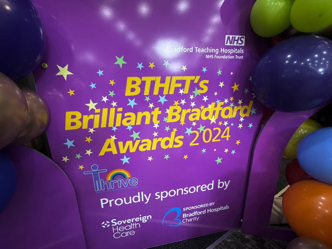 A sign reading “BTHFT’s Brilliant Bradford Awards’ surrounded by colourful balloons.