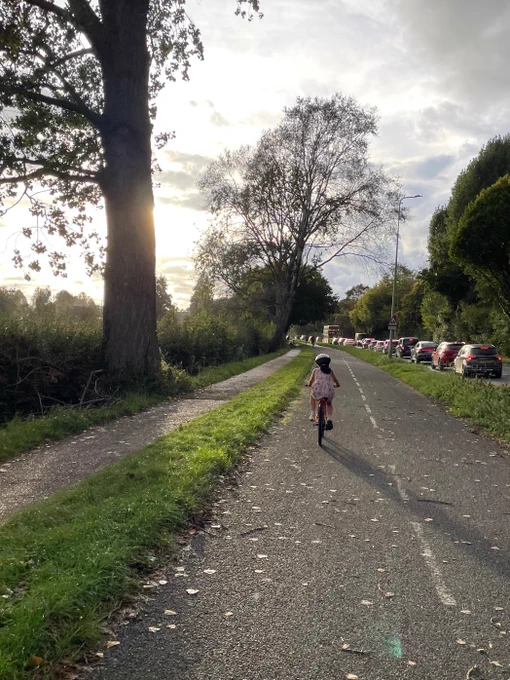 Child cycling independently on a 1970s segregated cycle way Marston Ferry Road, Oxford. 