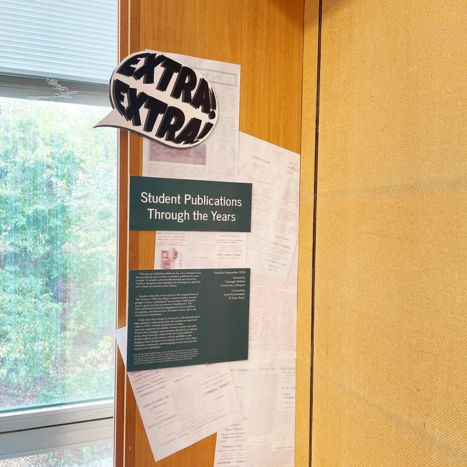 A sign on the wall that reads, "Extra Extra! Student Publications Through the Years."
