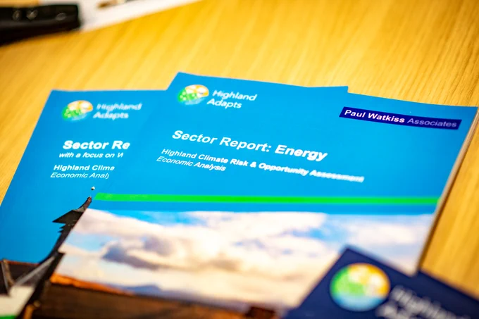 Images of blue coloured reports on a yellow table
