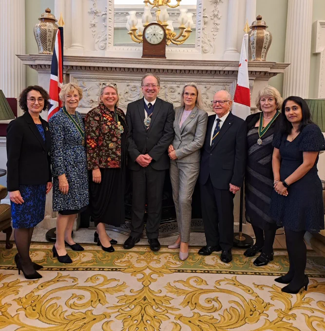 From L to R: Hayley, Past Master Felicity Harding OBE, Master Spectacle Maker Liz Shilling, The Lord Mayor Alderman Michael Mainelli, The Lady Mayoress Elisabeth Mainelli, Ivan, Past Master Christine Tomkins and Vaishali. Standing in The Lord Mayor's Office, smiling.